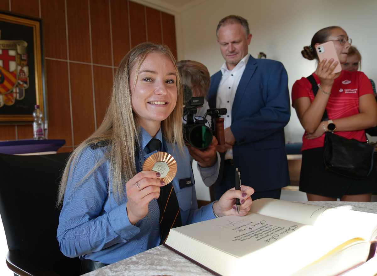 Unter den Augen von Oberbrgermeister Jan Einig und zahlreichen Medienvertretern trug sich Olympionikin Sophia Junk in das goldene Buch der Stadt Neuwied ein. (Fotos: Felix Banaski)